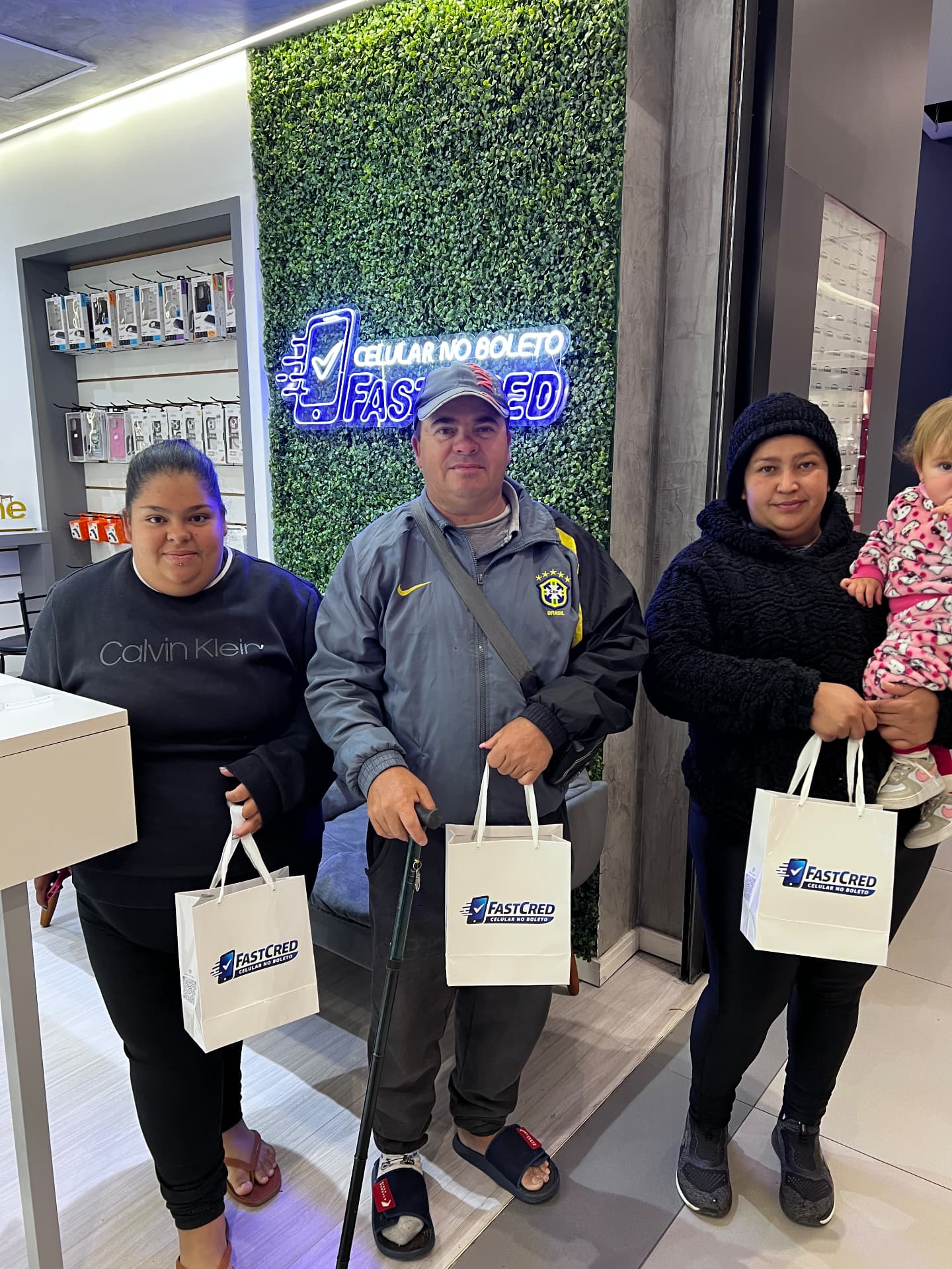 Família com sacolas FastCred na loja